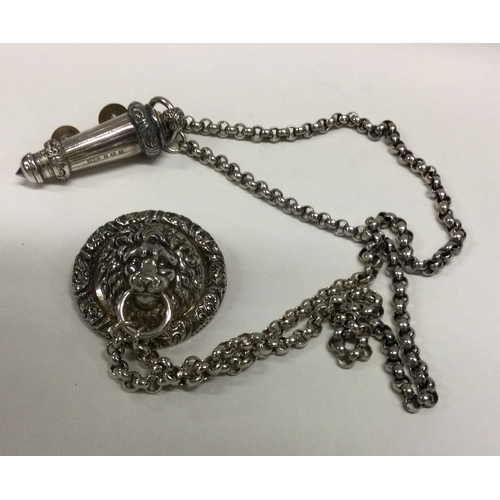 90 - A silver Policeman's whistle on chain with lion mask pin. Birmingham 1907. By J&Co. Approx. 125 gram... 