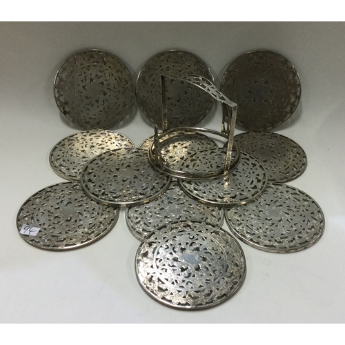 94 - A set of twelve Sterling silver wine coasters in matching holder. Approx. 449 grams. Est. £80 - £120... 