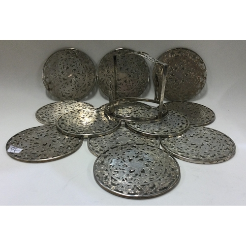 94 - A set of twelve Sterling silver wine coasters in matching holder. Approx. 449 grams. Est. £80 - £120... 