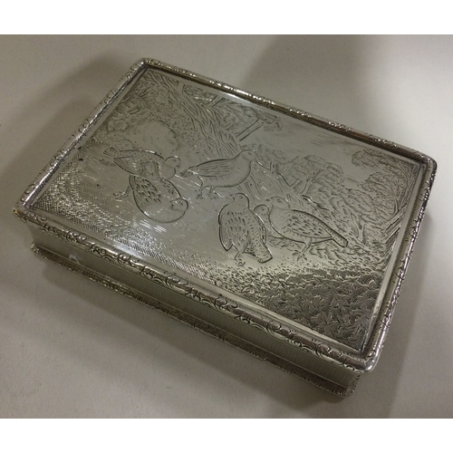 95 - A heavy silver snuff box decorated with birds. Approx. 175 grams. Est. £400 - £500.