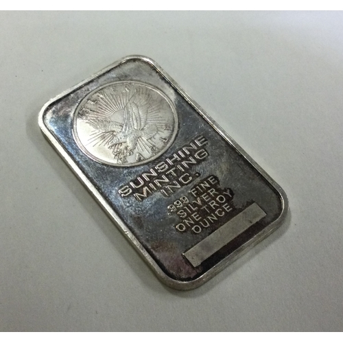 99 - A silver Troy ounce bar by The Sunshine Mint Company. Approx. 31 grams. Est. £30 - £40.