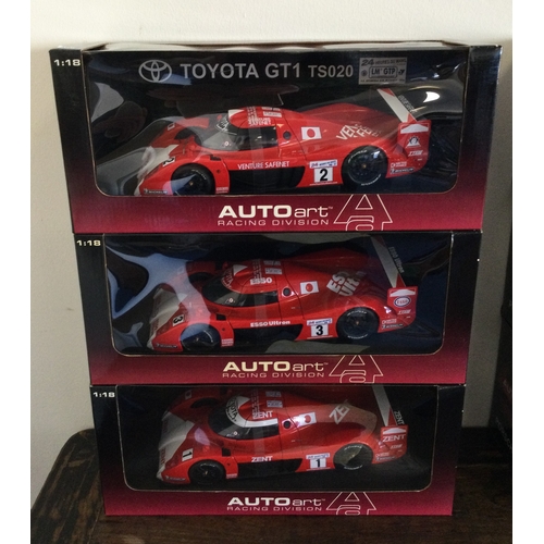 351 - AUTOart Racing Division: Three various boxed model racing cars, scale 1:18. Est. £20 - £30.