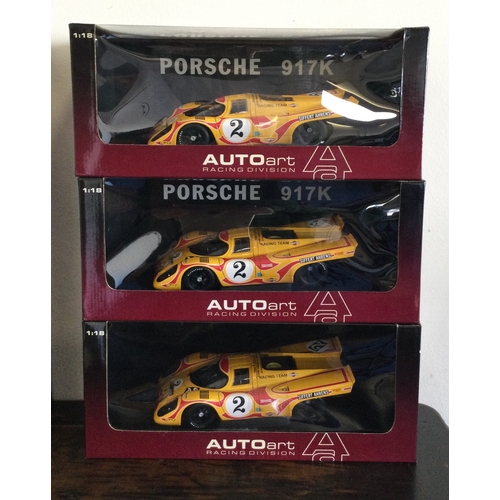 352 - AUTOart Racing Division: Three various boxed model racing cars, scale 1:18. Est. £20 - £30.