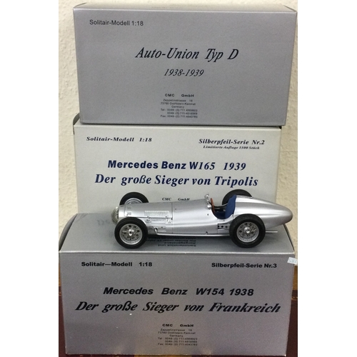 583 - CMC: Three 1:18 scale boxed model racing cars. Est. £100 - £200.