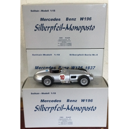 584 - CMC: Three 1:18 scale boxed model racing cars. Est. £100 - £200.