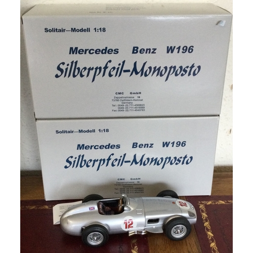 585 - CMC: Two 1:18 scale boxed model racing cars. Est. £100 - £200.