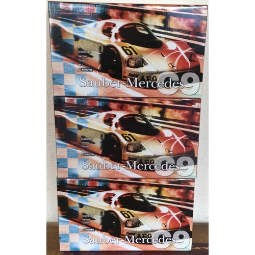 588 - RACING LEGENDS: Three various 1:18 scale boxed model racing cars. Est. £40 - £60.