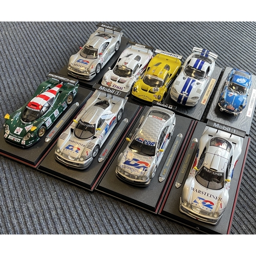 619 - Nine various unboxed1:18 scale model racing cars. Est. £30 - £40.