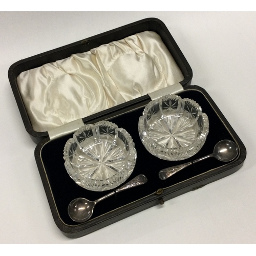 115 - A pair of silver mounted cut glass salts contained within a fitted box. Est. £20 - £30.