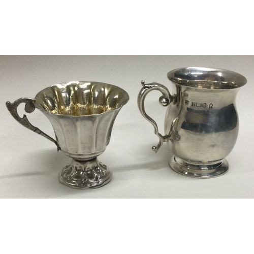 133 - Two miniature silver mugs. Approx. 40 grams.  Est. £20 - £30.