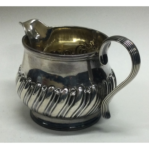 135 - A Victorian silver half fluted cream jug . London. Approx. 56 grams.  Est. £30 - £40.