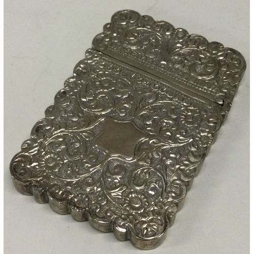 146 - A heavy 19th Century Indian silver card case of chased design. Approx. 94 grams. Est. £150 - £200.