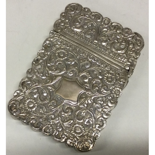 146 - A heavy 19th Century Indian silver card case of chased design. Approx. 94 grams. Est. £150 - £200.