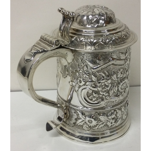 163 - A fine George I chased silver tankard embossed with tavern scene. London 1724.  Approx. 642 grams. E... 