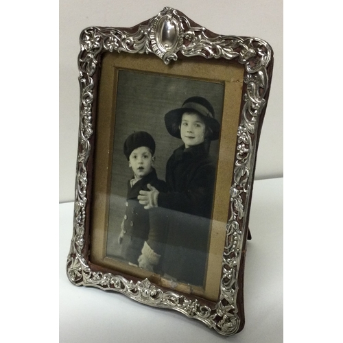 164 - A decorative Victorian silver rectangular photo frame with pierced decoration. Birmingham 1896. By H... 