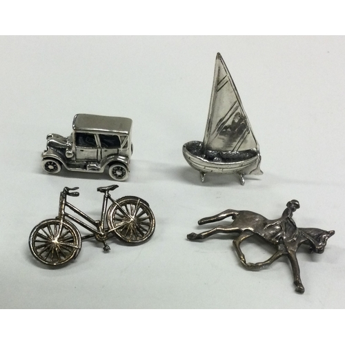 168 - A novelty silver car together with a novelty bicycle etc. Approx. 28 grams. Est. £20 - £40.