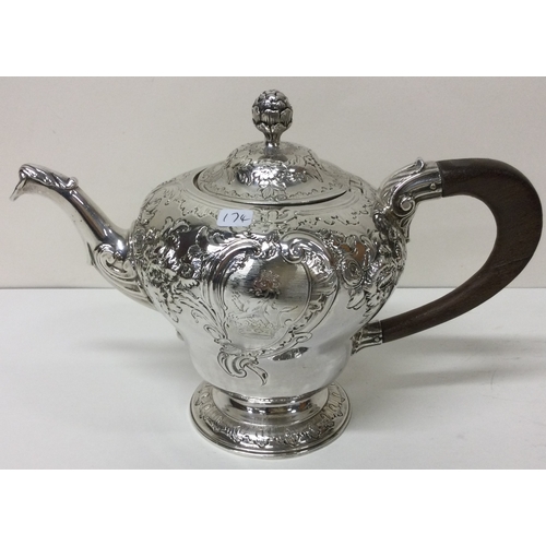 174 - An early George II silver crested chased teapot. London 1748. By John Swift.  Approx. 605 grams. Est... 