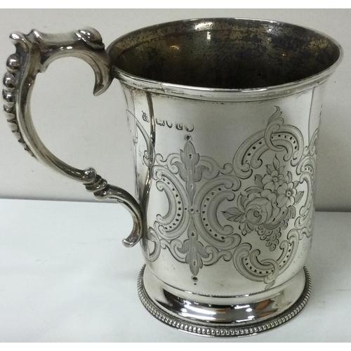 175 - A fine Victorian florally engraved silver christening mug. London 1874. By George and Edward Burrows... 