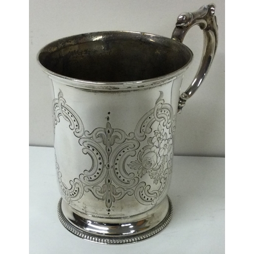 175 - A fine Victorian florally engraved silver christening mug. London 1874. By George and Edward Burrows... 