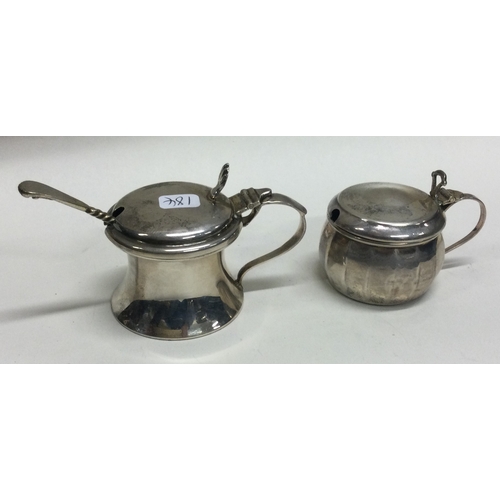 184 - Two heavy silver mustard pots with hinged tops. Approx. 47 grams. Est. £25 - £30.