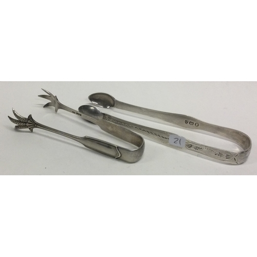 21 - NEWCASTLE: A pair of Georgian bright cut silver sugar tongs together with one other pair. Approx. 55... 