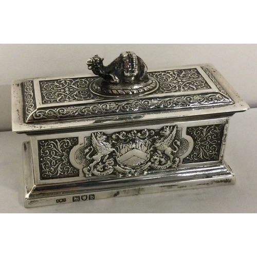 213 - A rare Victorian silver chased silver box with coat of arms to both sides. London 1897. By Spink and... 