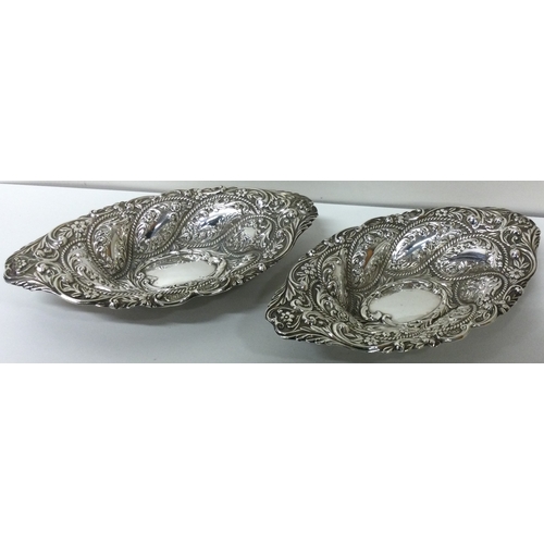 215 - A fine pair of chased silver dishes. Birmingham 1901. By Alexander Clark. Approx. 189 grams. Est. £2... 