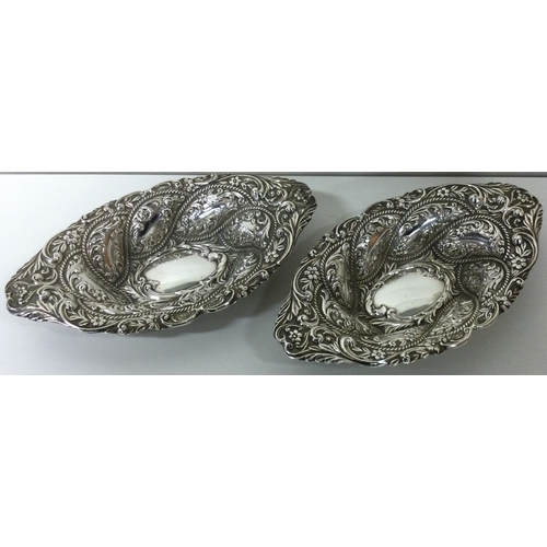 215 - A fine pair of chased silver dishes. Birmingham 1901. By Alexander Clark. Approx. 189 grams. Est. £2... 