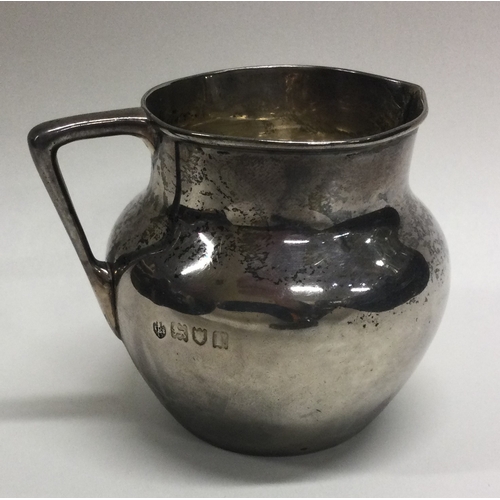 216 - A heavy silver cream jug of plain form. London. Approx. 62 grams. Est. £40 - £60.