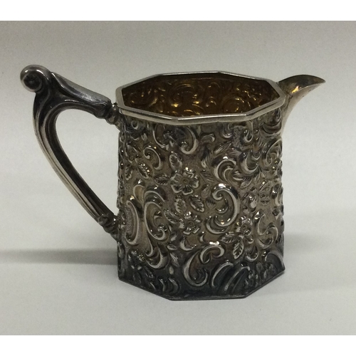 217 - An attractive silver cream jug with floral decoration. Birmingham. Approx. 44 grams. Est. £30 - £40.