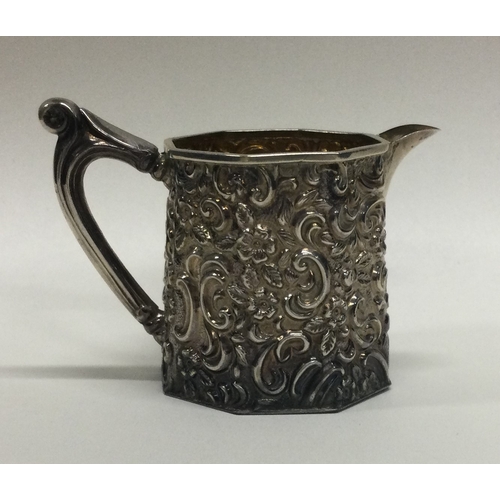 217 - An attractive silver cream jug with floral decoration. Birmingham. Approx. 44 grams. Est. £30 - £40.