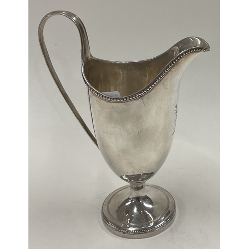 273 - A George III silver crested jug with beaded border. London 1780. Approx. 49 grams. Est. £120 - £150.