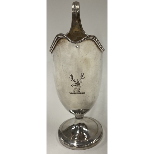 273 - A George III silver crested jug with beaded border. London 1780. Approx. 49 grams. Est. £120 - £150.