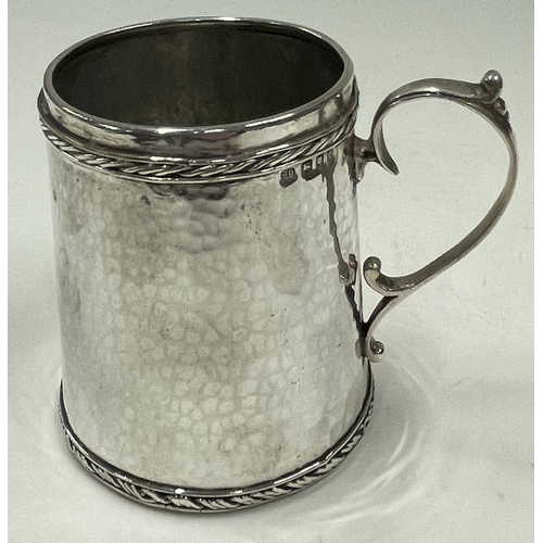 286 - SIBYL DUNLOP: A rare silver hammered mug with embossed border. London 1920. Approx. 104 grams. Est. ... 