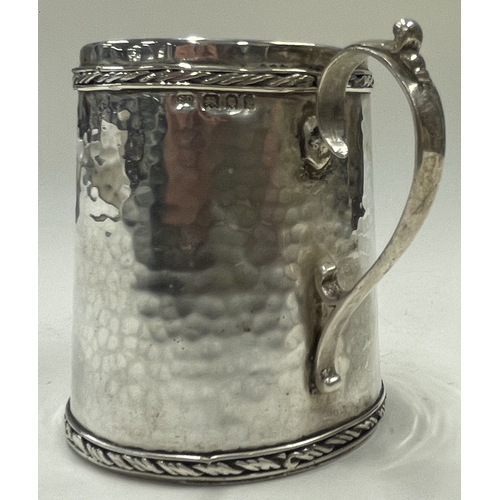 286 - SIBYL DUNLOP: A rare silver hammered mug with embossed border. London 1920. Approx. 104 grams. Est. ... 