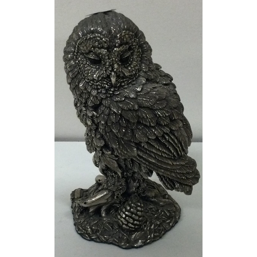 299 - A heavy silver model of an owl on a bark branch. Birmingham 1984. Est. £40 - £60.