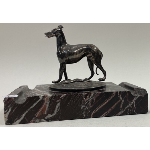 30 - A silver figure of a dog on stand. Approx. 894 grams gross weight. Est. £300 - £500.