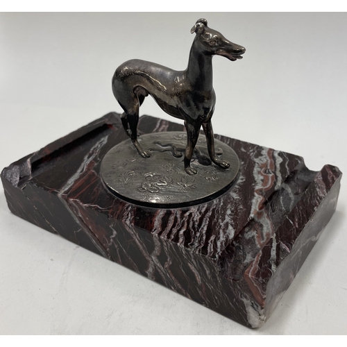 30 - A silver figure of a dog on stand. Approx. 894 grams gross weight. Est. £300 - £500.