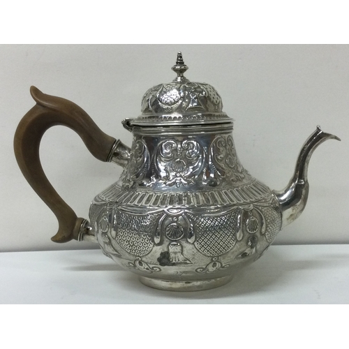 49 - An early chased 18th Century Dutch chased teapot. Approx. 284 grams. Est. £800 - £1000.