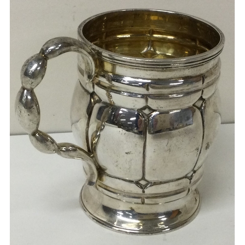 57 - A heavy Victorian silver christening mug with unusual handle. London 1863. By Daniel and Charles Hou... 