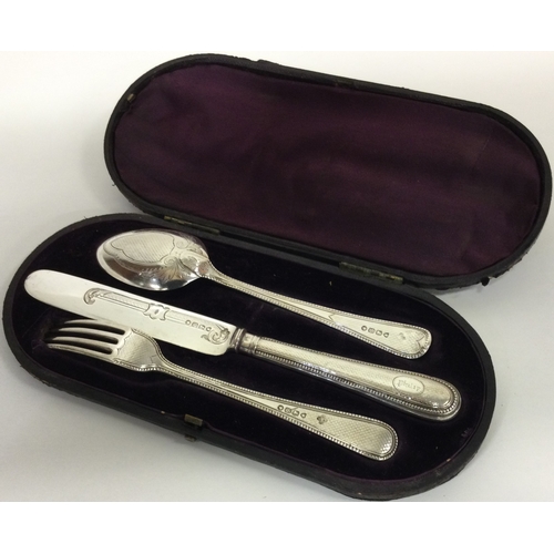 72 - A cased three piece silver christening set. London 1873. By Edward and John Barnard. Approx. 104 gra... 