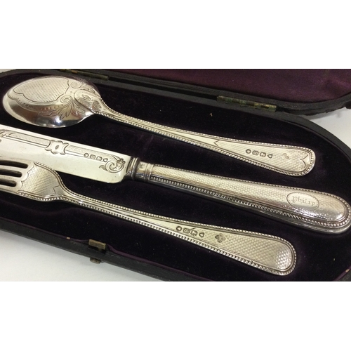 72 - A cased three piece silver christening set. London 1873. By Edward and John Barnard. Approx. 104 gra... 