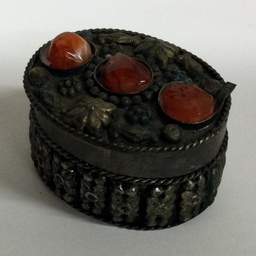 84 - A Continental silver jewellery box mounted with stones. Approx. 27 grams. Est. £20 - £30.