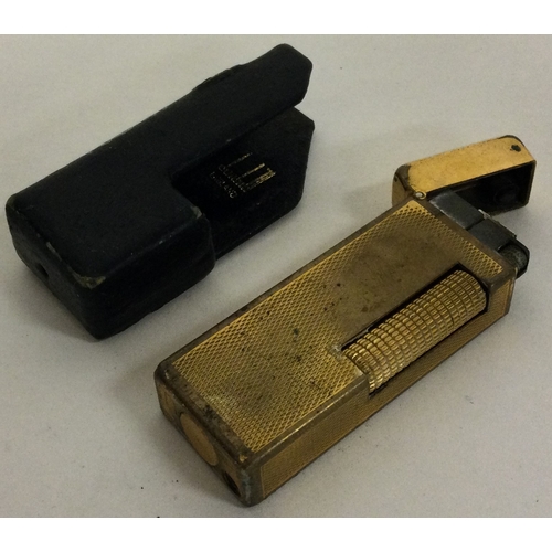 87 - A Dunhill gold plated lighter in original Dunhill sleeve. Est. £20 - £30.