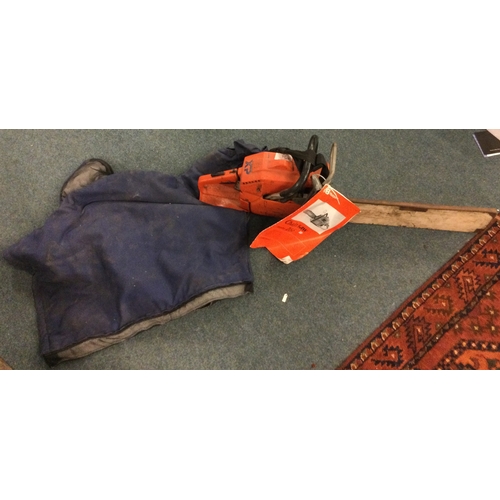 838 - A Husqvarna chain saw together with a jacket. Est. £20 - £30.