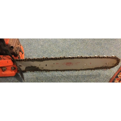 838 - A Husqvarna chain saw together with a jacket. Est. £20 - £30.