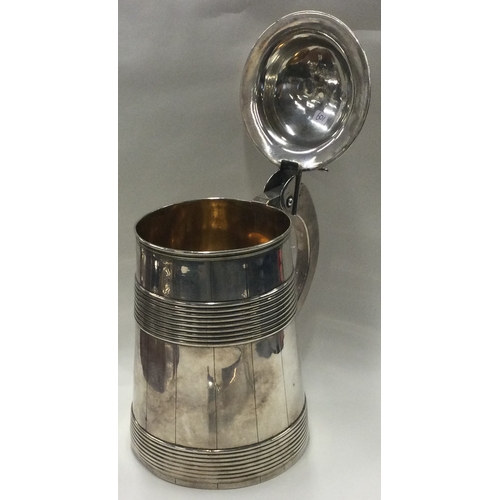 109 - A large 18th Century George III silver lidded barrel tankard. London 1771. By William Holmes. Approx... 