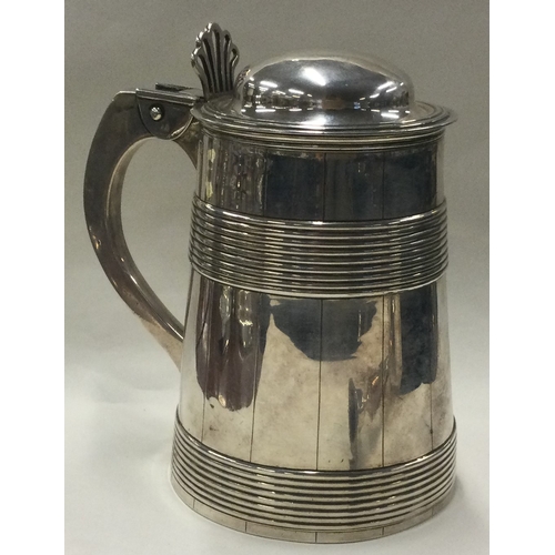 109 - A large 18th Century George III silver lidded barrel tankard. London 1771. By William Holmes. Approx... 