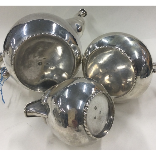 126 - A three piece Danish silver coffee set in the style of Georg Jensen. Marked to base. Approx. 868 gra... 