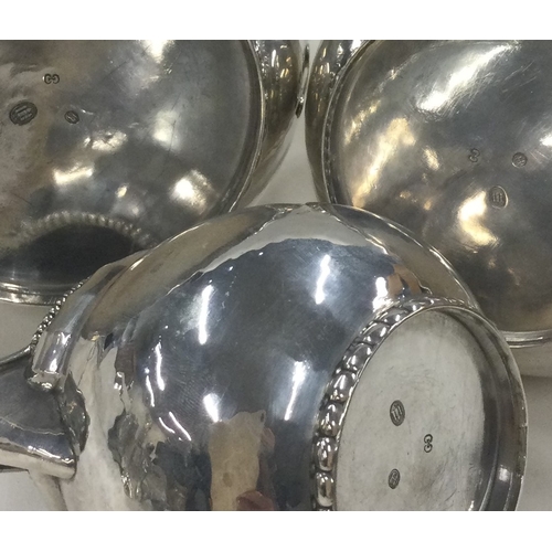 126 - A three piece Danish silver coffee set in the style of Georg Jensen. Marked to base. Approx. 868 gra... 